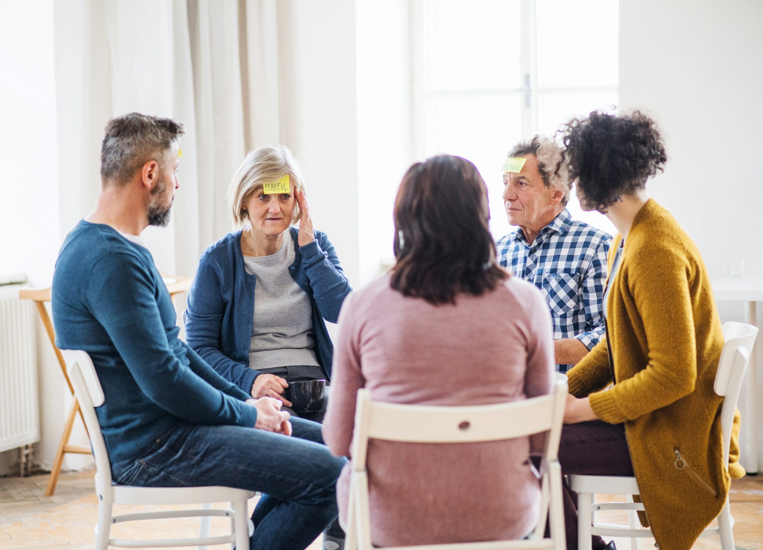 Group of individuals sit in a circle by getty-images